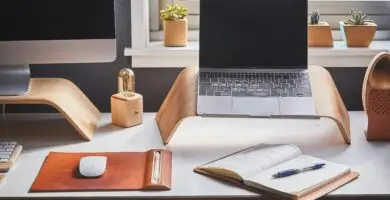 A stylish and contemporary home office setup with laptop and desk accessories.