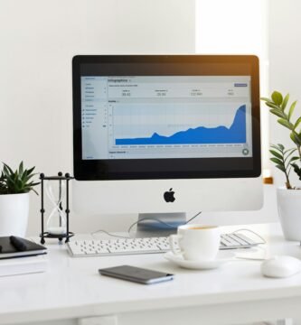 A clean, contemporary workspace featuring a desktop with analytics on the screen and plants for a fresh look.