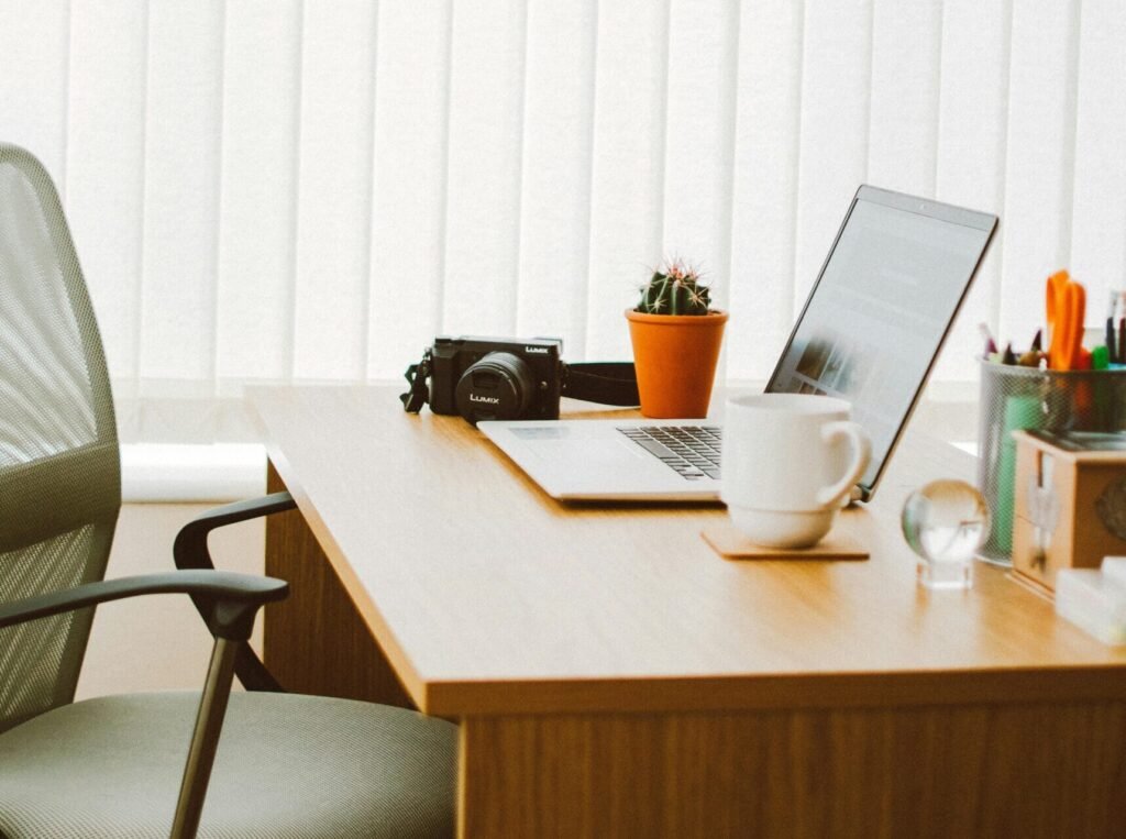 A clean and bright home office setup with a laptop, chair, and desk essentials.