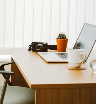 A clean and bright home office setup with a laptop, chair, and desk essentials.