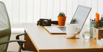 A clean and bright home office setup with a laptop, chair, and desk essentials.