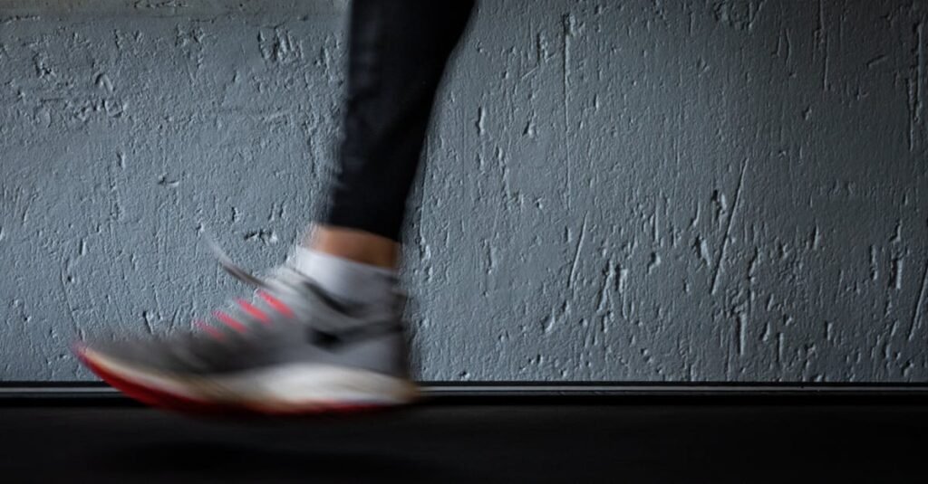 Blurred image of a person running on a treadmill, highlighting movement and fitness.