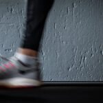 Blurred image of a person running on a treadmill, highlighting movement and fitness.
