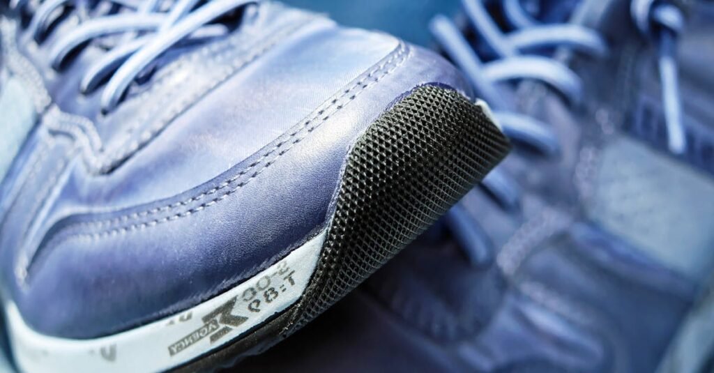 Detailed view of blue athletic sneakers showcasing mesh textures and laces.