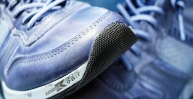 Detailed view of blue athletic sneakers showcasing mesh textures and laces.